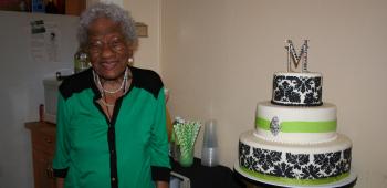 Mable Allen stands with the three-tiered cake family and friends enjoyed for her birthday.
