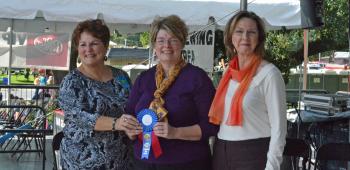 Letha Vincent, left, and Mary Jemison, right, presented the 2013 IRF Rice and Creole Cookery Contest Chef de Riz award to Michelle Puissegur, center, whose dish took first place in the Adult Rice and Seafood category.