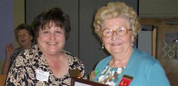  Epsilon State Treasurer Linda Ruth Jackson, left, presented Jo-Anne Arnaud, right, a plaque in appreciation of her 29 years of outstanding service as Xi Chapter treasurer.