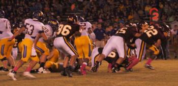 Iota defenders make a tackle behind the line of scrimmage.