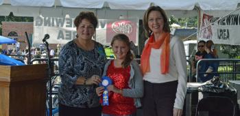 Letha Vincent, left, and Mary Jemison, right, presented the 2013 IRF Rice and Creole Cookery Contest Junior Chef de Riz award to Kallie Pitre, center who took first place in the Children’s Rice and Seafood category.