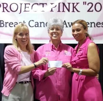 Chairperson Theresa Prather, center, makes a donation to Susan B. Komen representatives Lori Tursic, left, and Marka Johnnie, right, during the 2013 Project Pink Breast Cancer Awareness event held at the Rayne Civic center. 