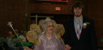 2012 Golden Age Queen Lillian Racca enters with her escort, Cade Abshire.