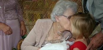 2013 Golden Age Queen Agnes Primeaux gives a quick kiss to her great-granddaughter, Zoe Rose Trahan, who served as her crown bearer.
