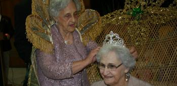 2012 Golden Age Queen Lillian Racca offers 2013 Queen Agnes Primeaux words of advice as she crowns her.