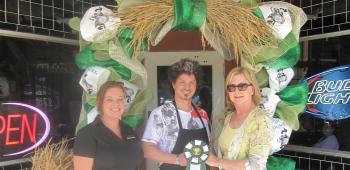 Taking second place in the business category of Crowley Garden Club’s IRF Door Decorating Contest was Zeus’s restaurant. Accepting the award from Crowley Garden Club member Patti Lawrence, far right, were, from left. Elise Faul and Yaser Balbiesi.