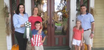 Second place in the residential category of the Crowley Garden Club’s IRF door decorating contest went to Diana and Dr. Mark Broussard, second from left and far right, respectively. Presenting them with their award is Crowley Garden Club member and door decorating chair Nancy Broadhurst. With them are two of the Broussards’ children, from left, Owen and Grace. 