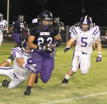 Brice Meche (8) and T.J. Bearb (5) bring down a LaGrange runner during Rayne's 14-12 district win over the Gators Friday night in Lake Charles.