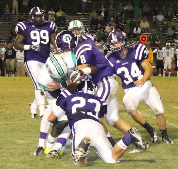 Rayne defenders make a tackle Thursday during the Wolves' 23-11 district loss to Eunice High School.