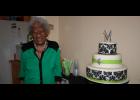 Mable Allen stands with the three-tiered cake family and friends enjoyed for her birthday.