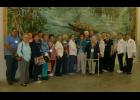 ELDERBERRY SENIORS paused for a group photo Oct. 2 in front of a mural at the Louisiana Spirts headquarters in Lacassine, one of three stops as they celebrates the group’s 13th anniversary. 